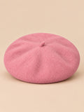 Béret français femme en pure laine rose, vue de face sur fond beige