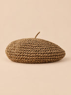 Béret plat effet paille Kaki, vue de face sur fond pêche sable