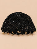 Béret rétro noir ajouré au crochet à franges d'étoiles dorées, vue de face sur fond pêche sable