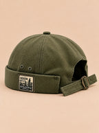 Bonnet docker réversible vert, vue de trois quarts.