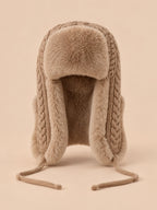 Bonnet péruvien à cache-oreilles kaki beige, vue de face sur fond pêche sable