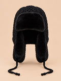Bonnet péruvien à cache-oreilles noir, vue de face sur fond pêche sable