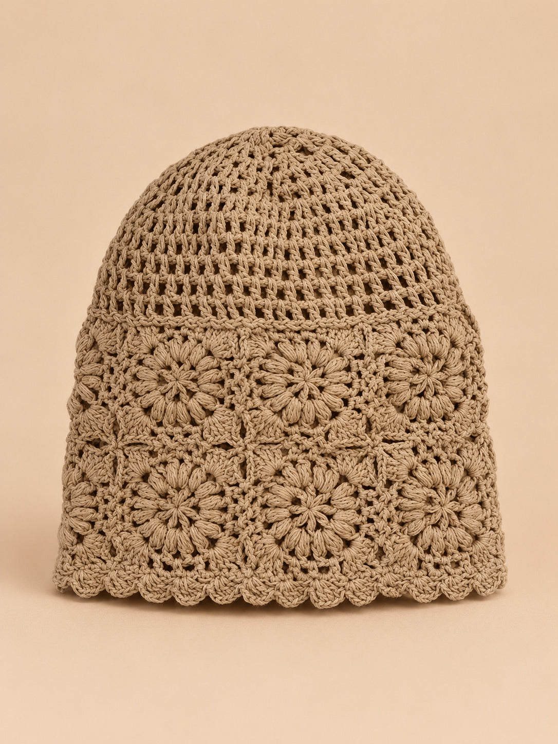 Bonnet turban femme kaki ajouré à fleurs au crochet, vue de face sur fond pêche sable