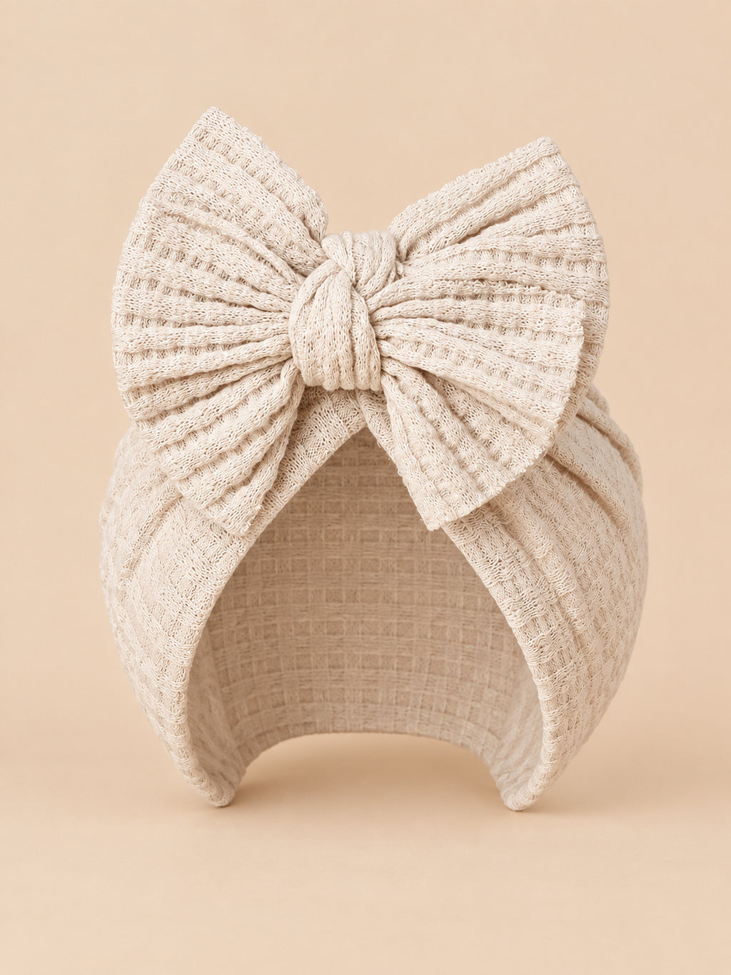 Bonnet turban bébé fille en coton tricoté beige clair, nœud, vue de face