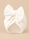 Bonnet turban bébé fille en coton tricoté blanc, nœud, vue de face